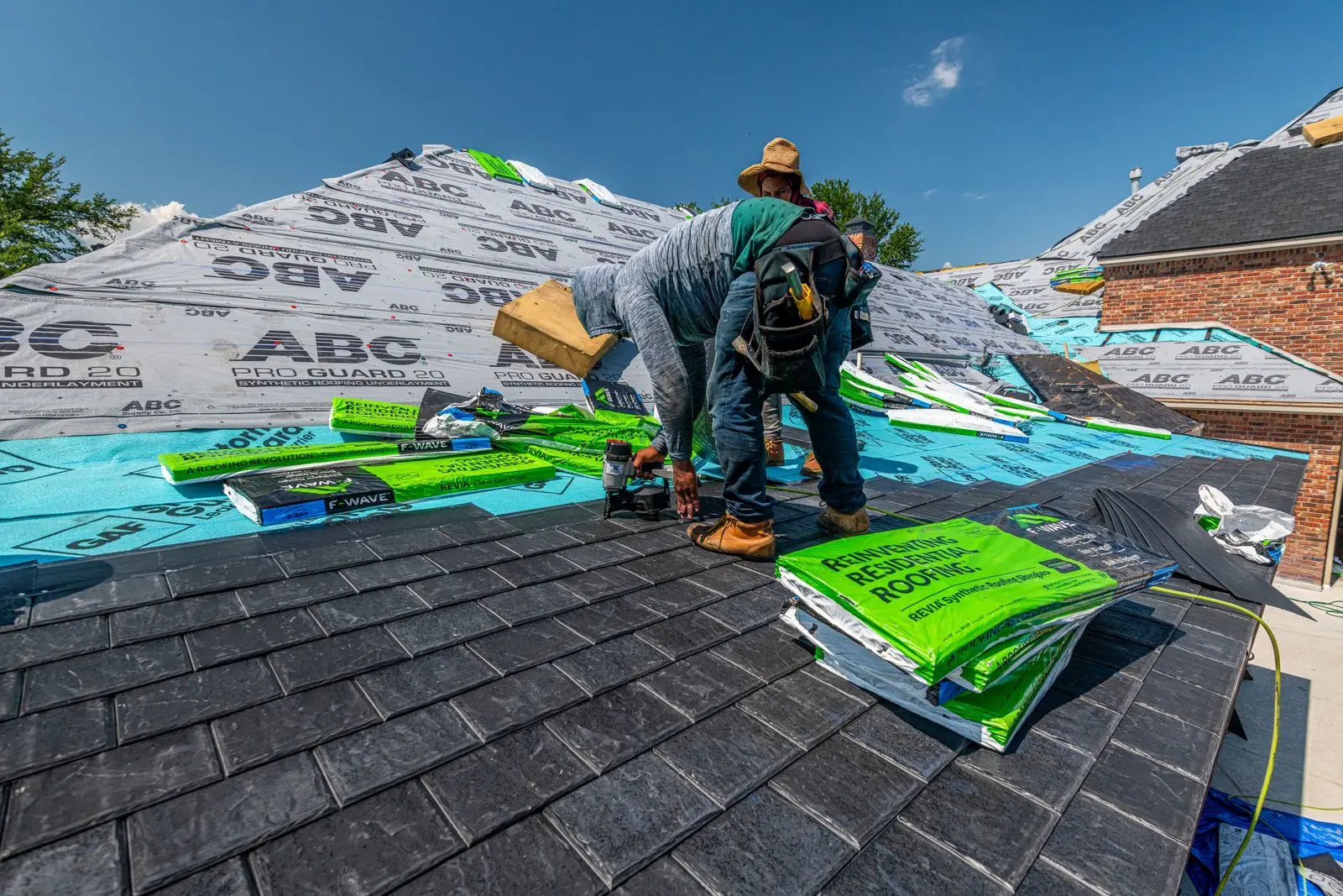 Example before: roofers installing underlayment during a tear-off